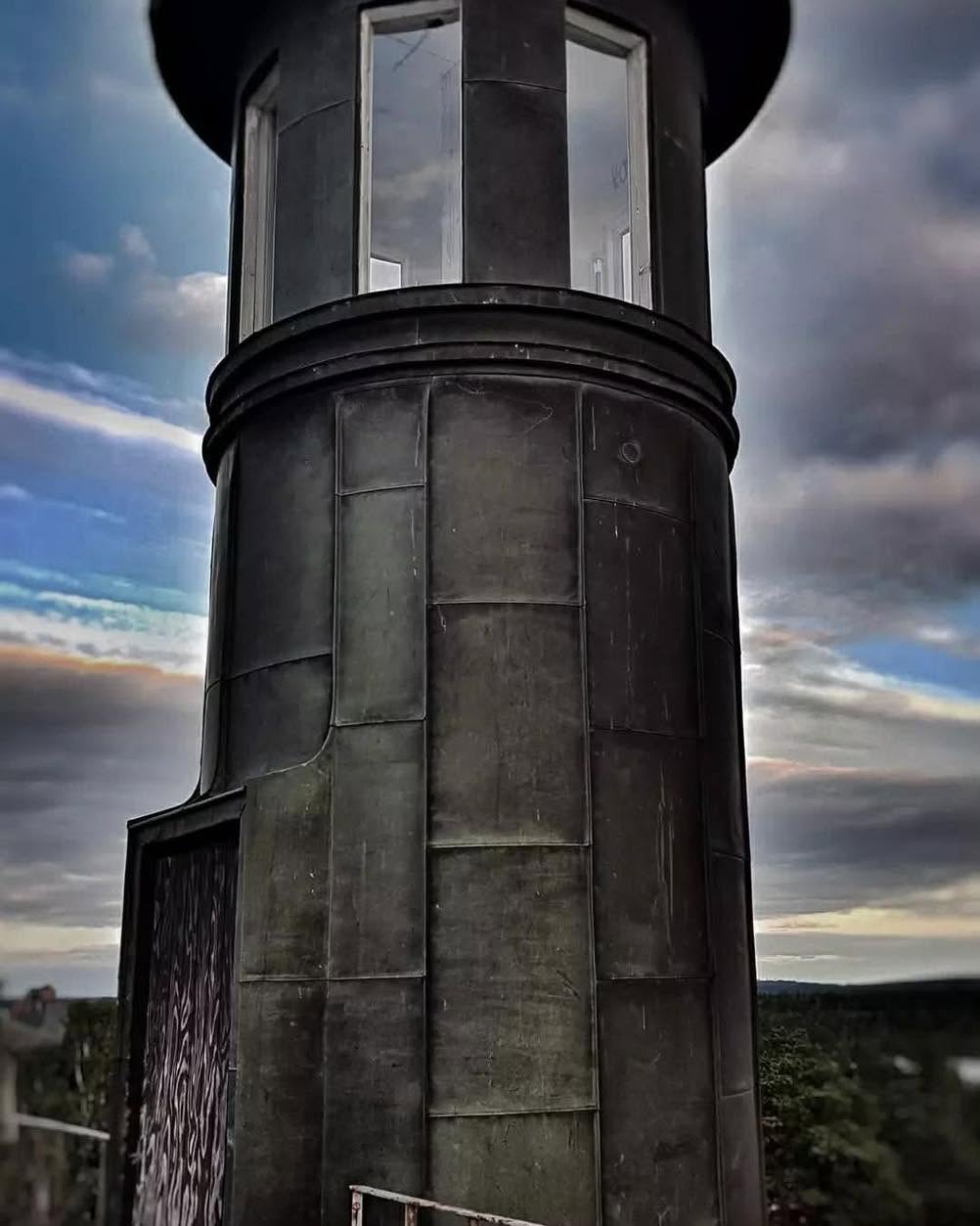The sanatorium’s sheet-metal tower with its glazed top against a dramatic sky